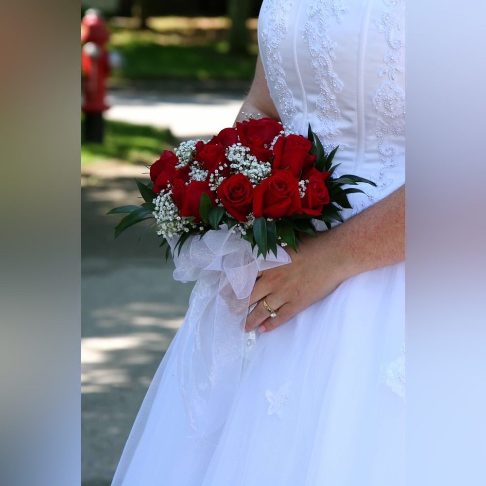 Oleg Cassini White Bridal Gown with Red Rose Bouquet